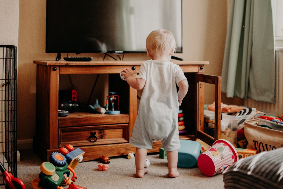 baby in LR with toys mess