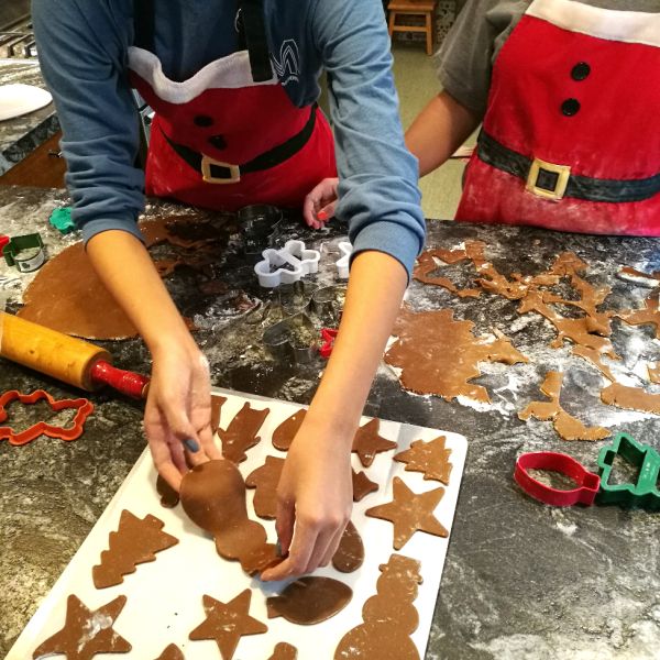 hands w cookie dough holiday gingerbread cookies being made