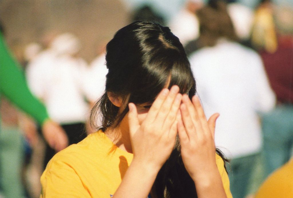 woman holding hands up