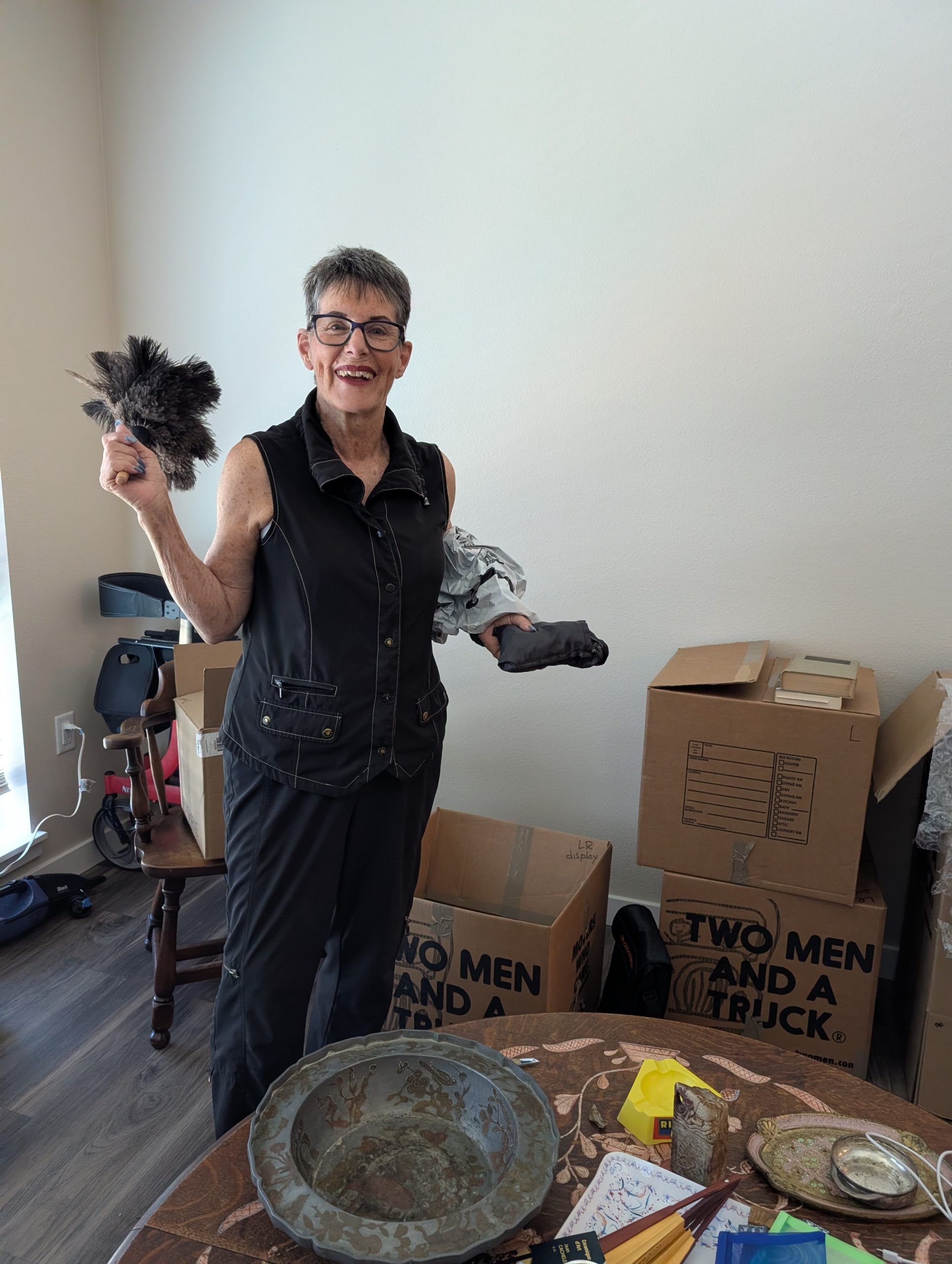 lady with packed boxes and a duster