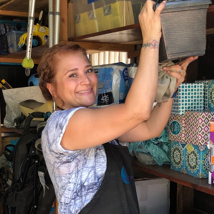 Gina smiling and working in a garage