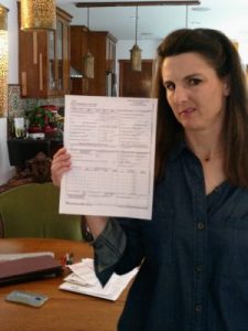 woman holding health insurance paperwork
